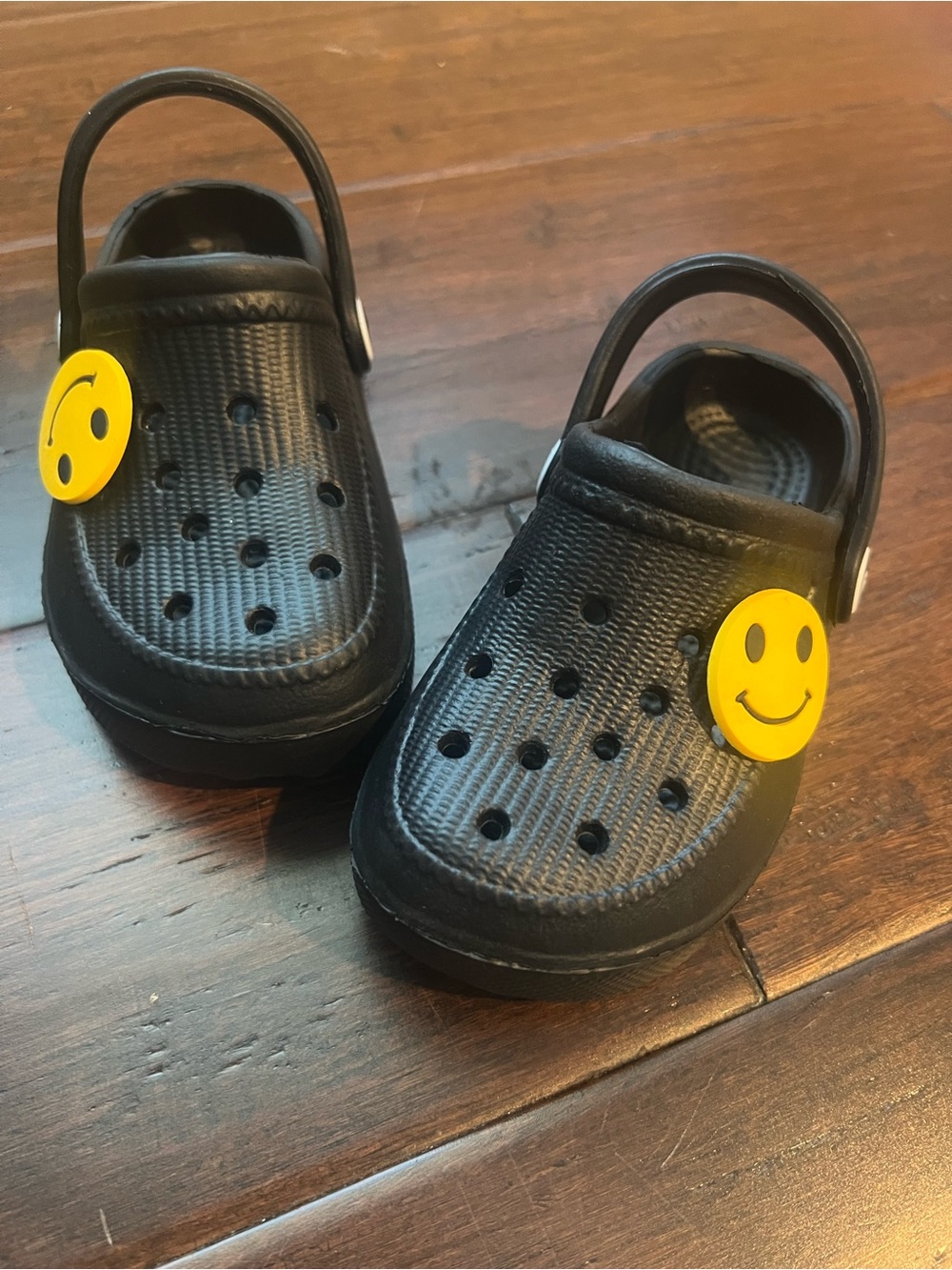 Kids Black Clog Shoes with Yellow Smile Charm - looks like a size 7